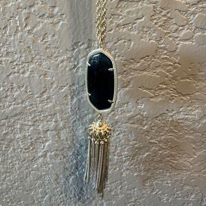Long black and gold Kendra scott necklace.